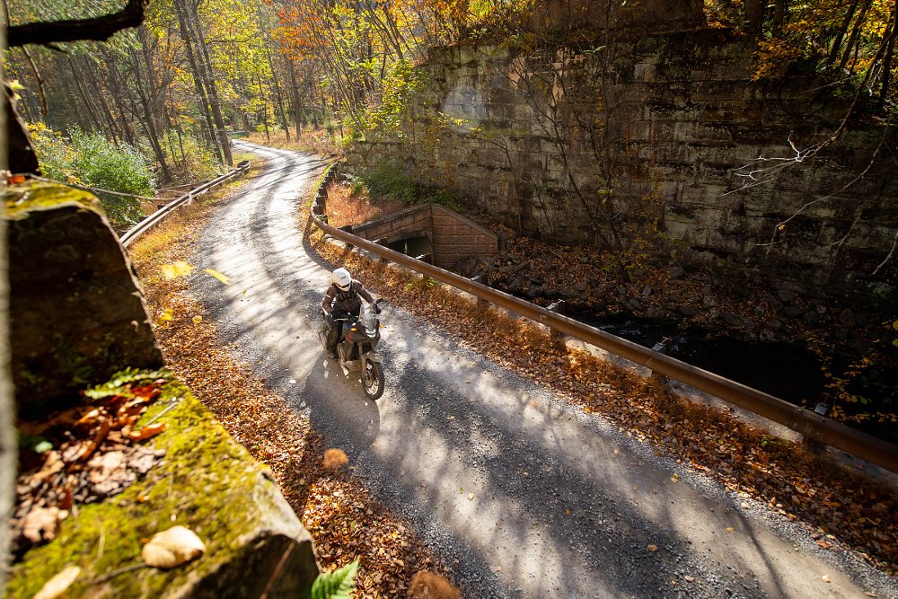 aerial view of the Transalp ridden on a two-track dirt road through woods