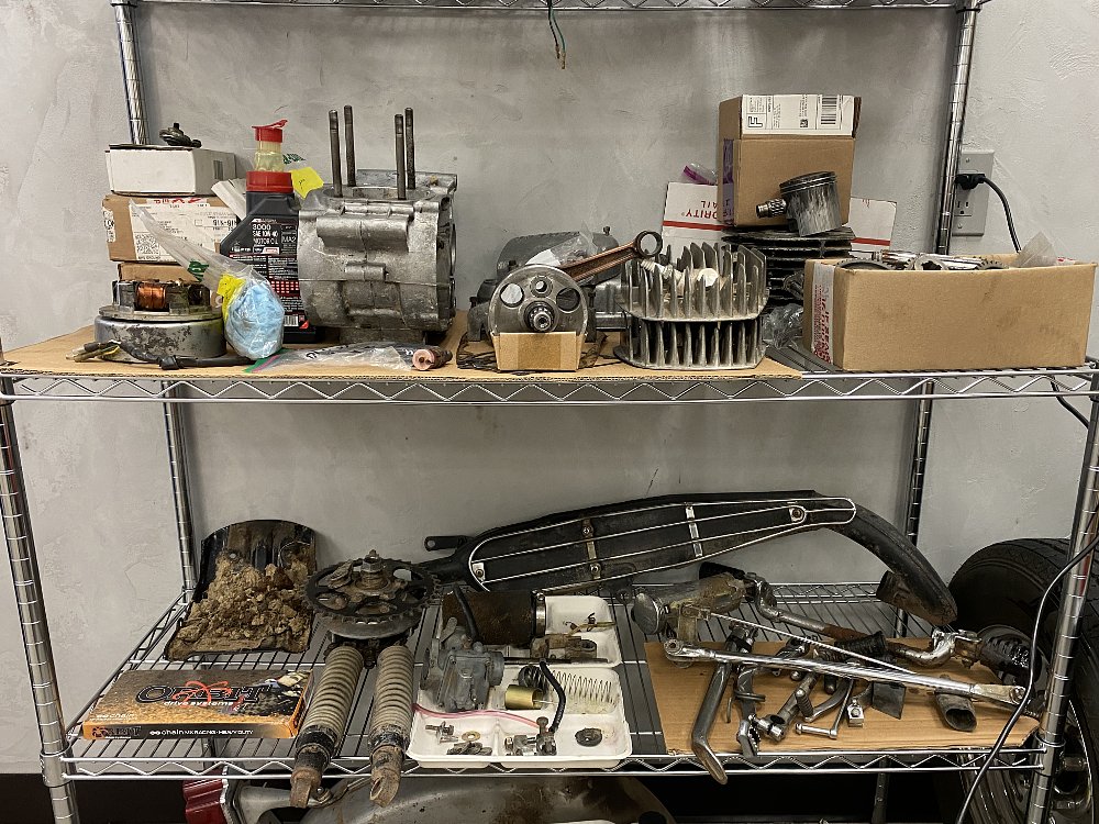 Motorcycle parts on a shelf. 