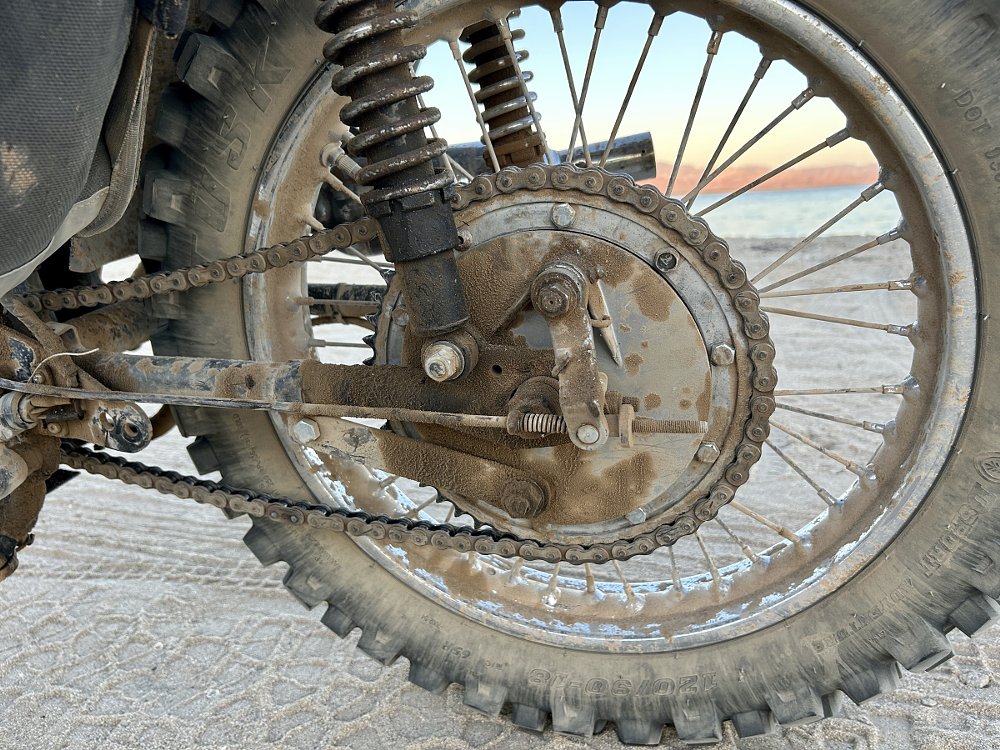closeup of mismatched bolts holding the sprocket on