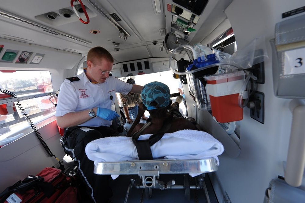 A medic treats a patient inside a helicopter air ambulance