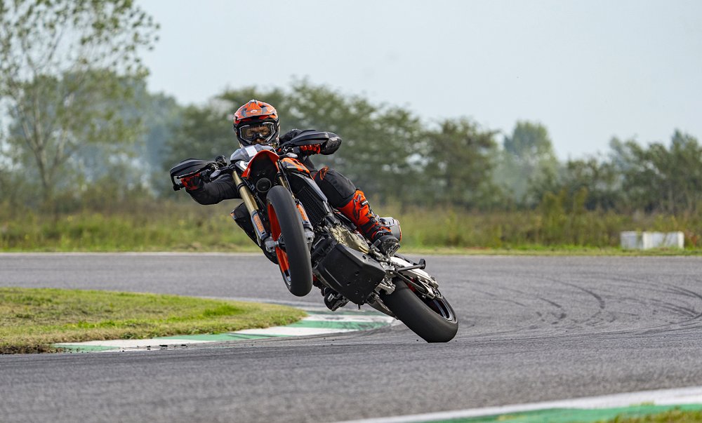 a test rider wheelies the Hypermotard on the race track