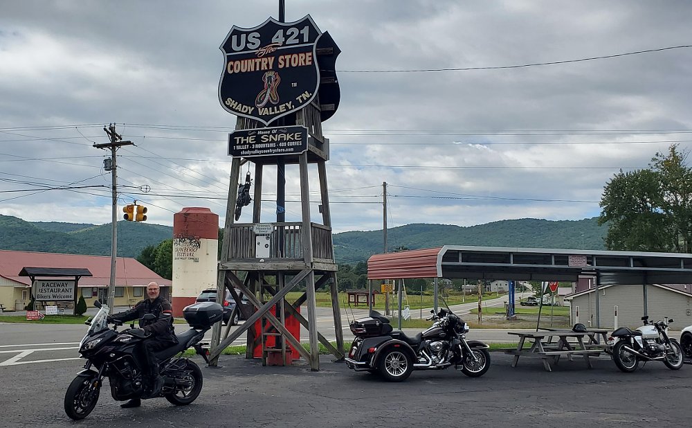 Peter on the motorcycle in front of a sign announcing the Snake