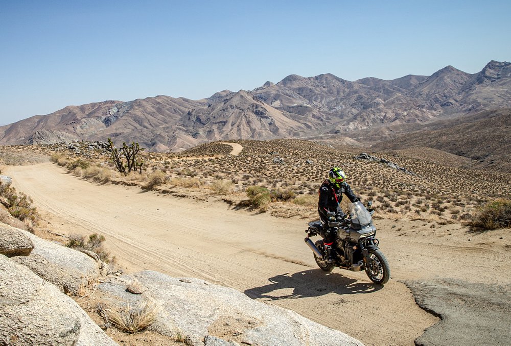 rider on a Pan America on a desert dirt road