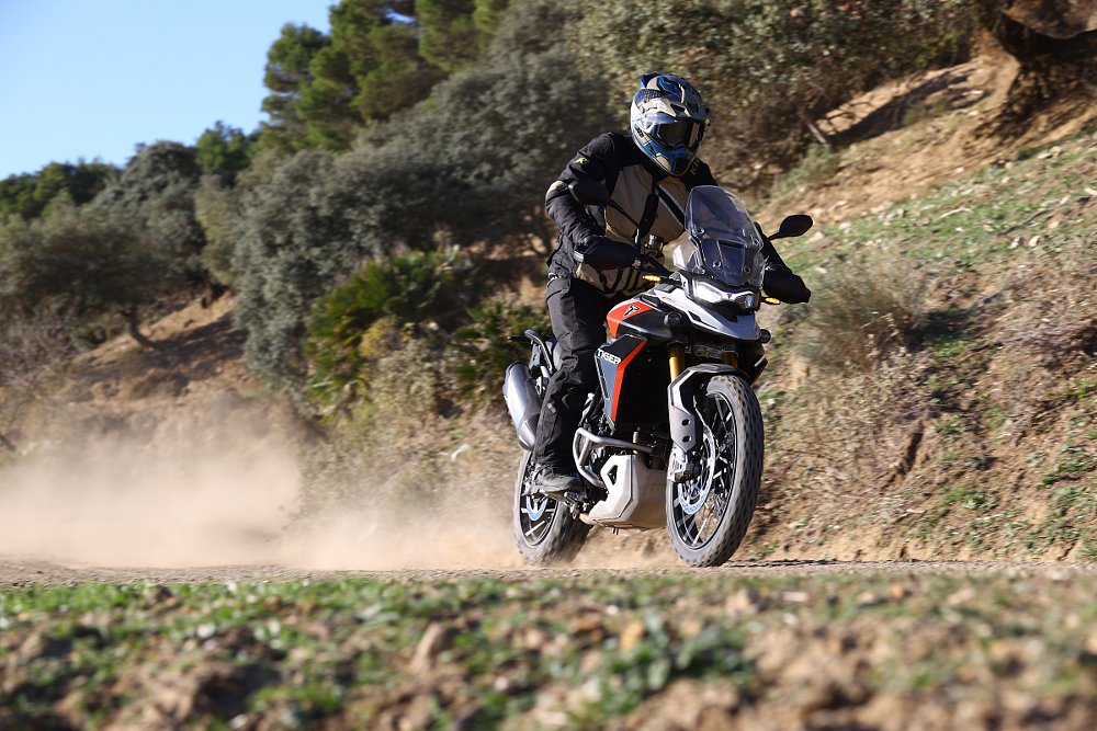 riding the Triumph Tiger 900 GT Pro on a dirt road in Spain