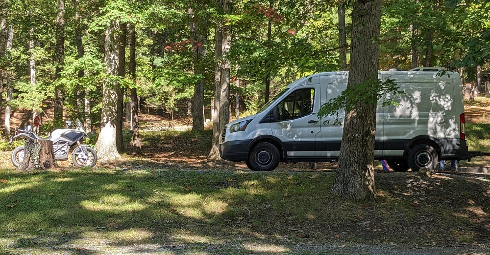 the Zero DSR/X and the camper van parked at the camp site