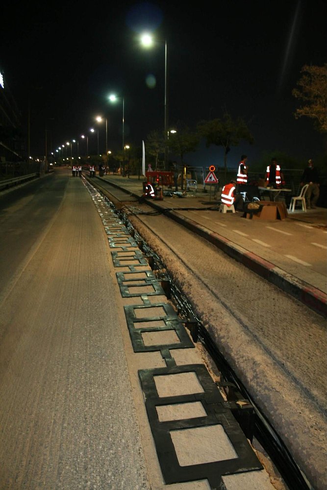 A photo of the coper coil plates being installed into a roadway