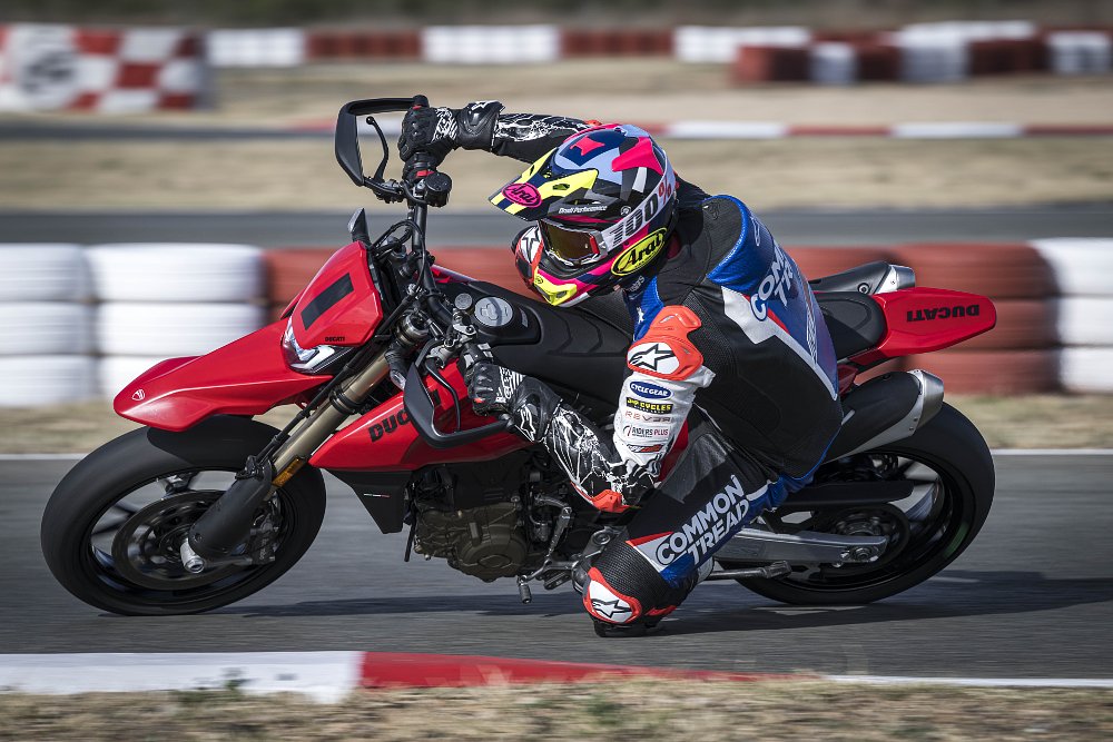 2024 Ducati Hypermotard 698 riding around a left-hand corner at a race track.