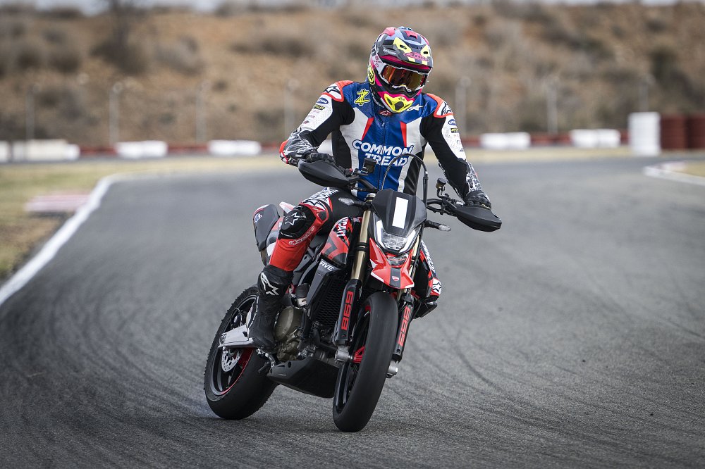 2024 Ducati Hypermotard 698 riding toward camera into a left-hand turn.