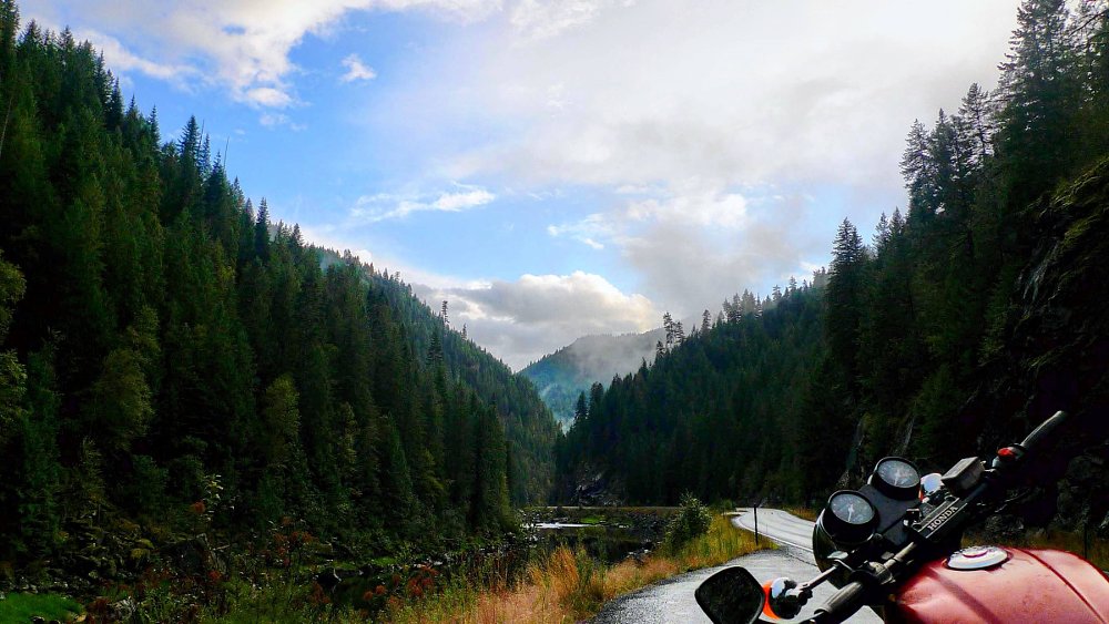 view of a mountain road over the handlebar of the Honda CB450