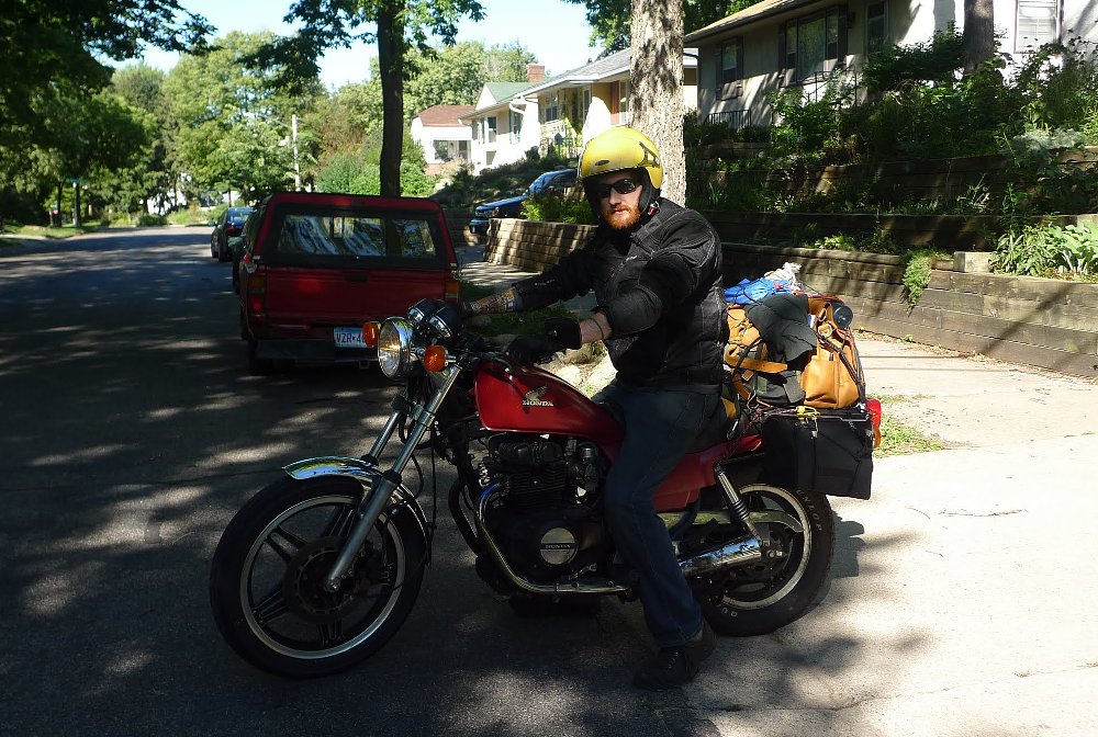 rider on the old Honda motorcycle, loaded for a long trip