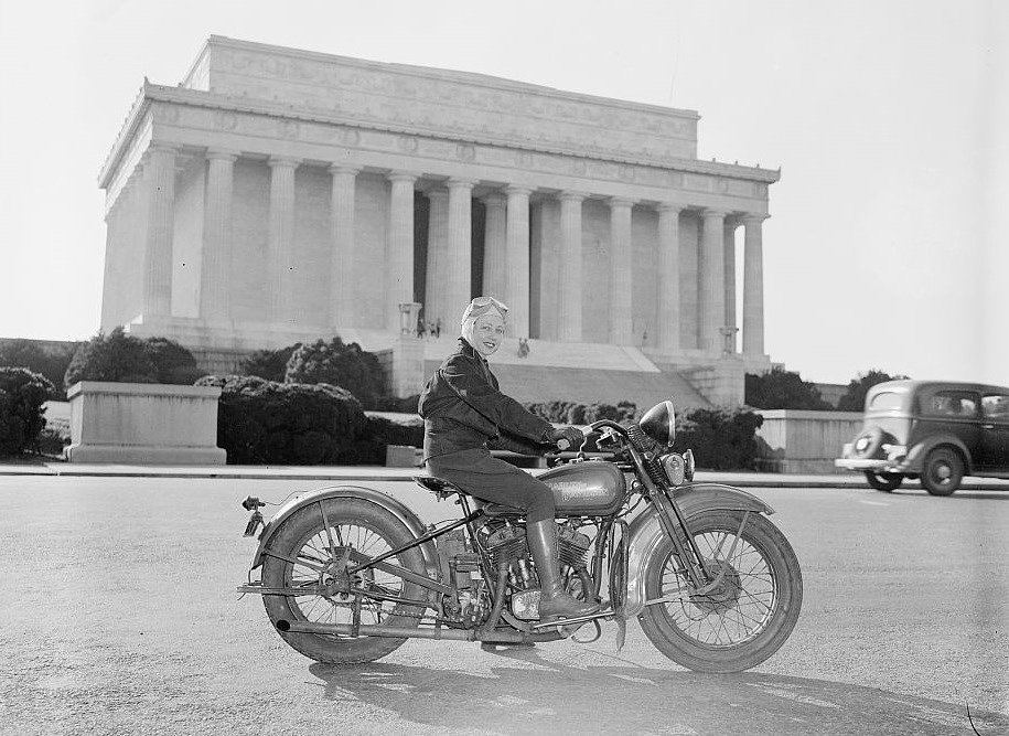 1937 black and white photo of woman on a motorcycle in front of the Lincoln Memorial