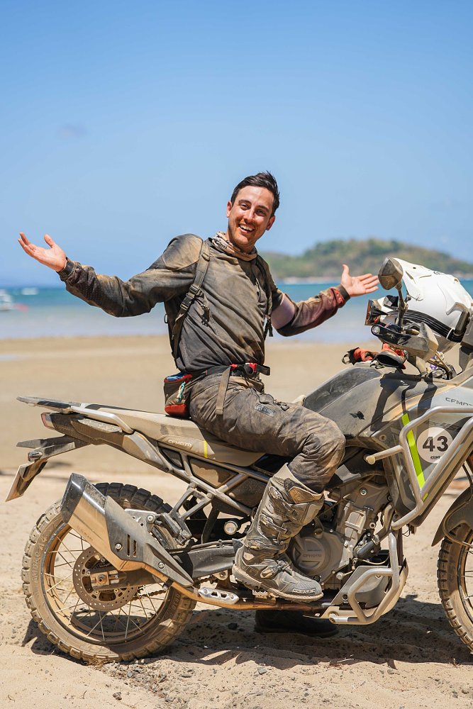 dirt-covered rider smiling on the Ibex 450