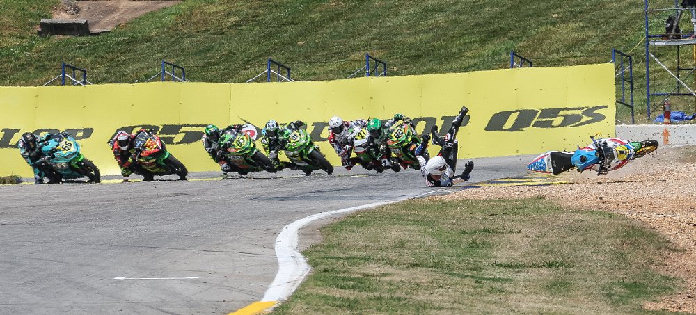 Avery Dreher crashing his motorcycle in front of a pack of riders at Road Atlanta