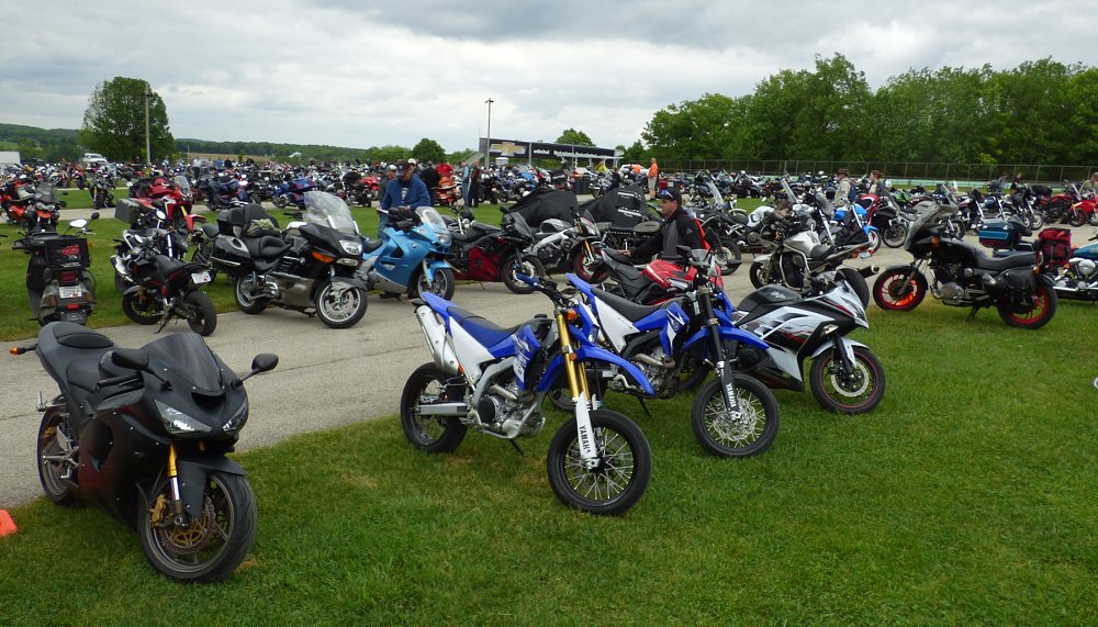 variety of motorcycles in the grassy parking area at Road America