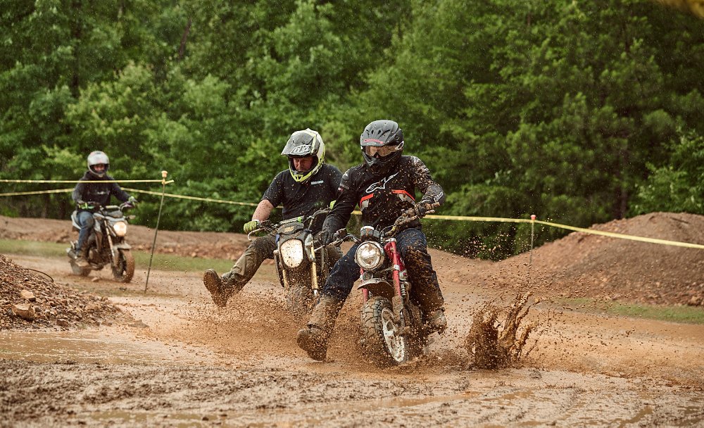 Groms racing in the mud and rain on an off-road track