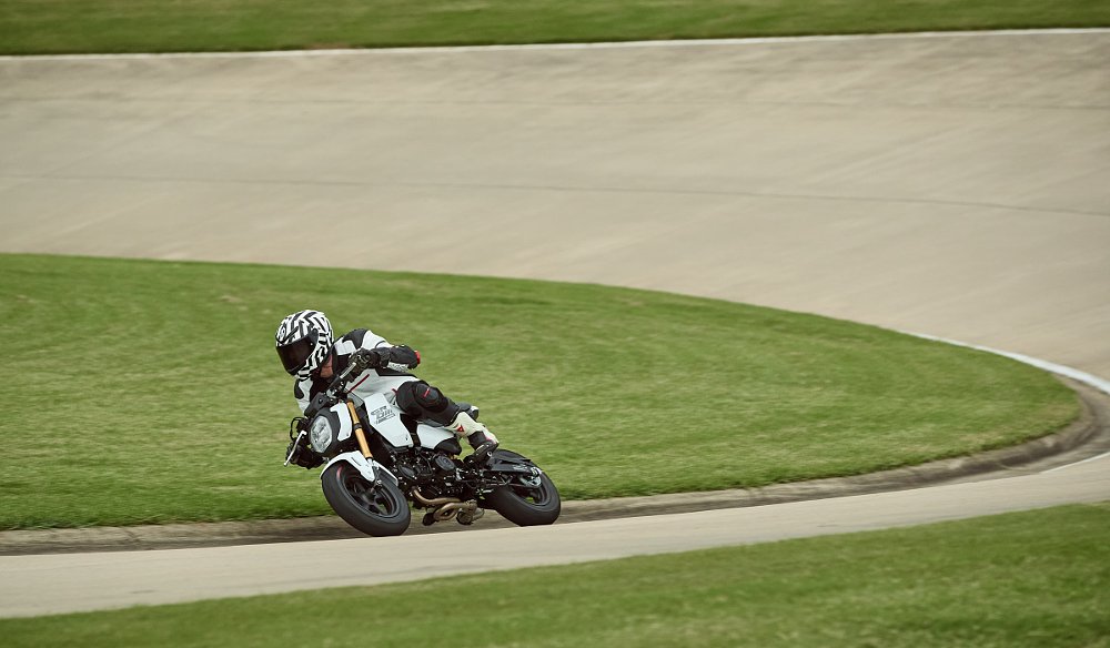 racing the Grom on a track, leaned over in a curve
