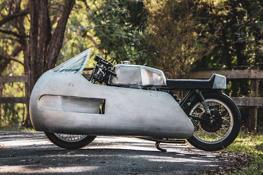 side view of the Moto Guzzi with an unpainted aluminum dustbin fairing