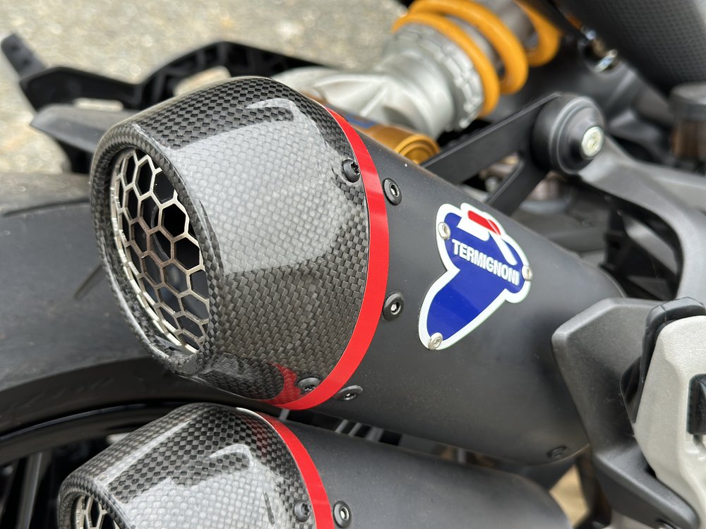 Detail of the Termignoni muffler on a 2024 Ducati Monster SP.
