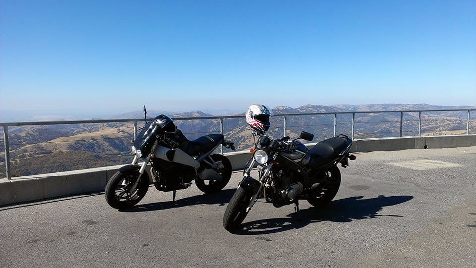 Buell and a Suzuki parked at a roadside mountain overlook