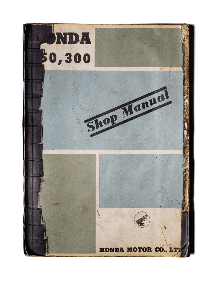 old shop manual, held together by tape