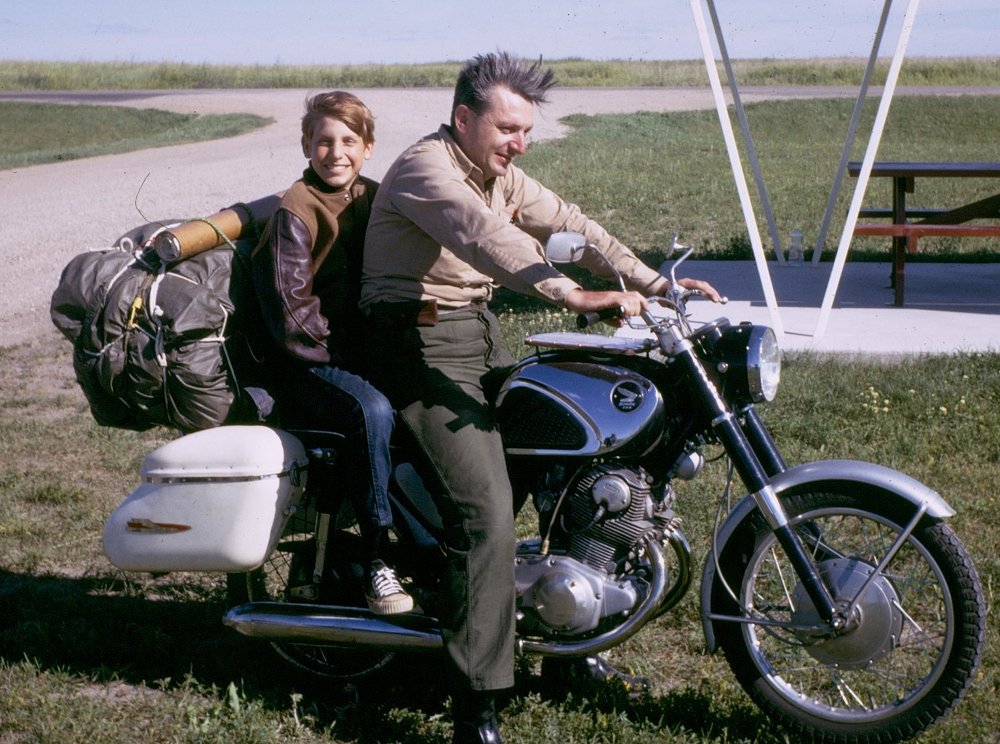 Pirsig and his young son seated on the Honda