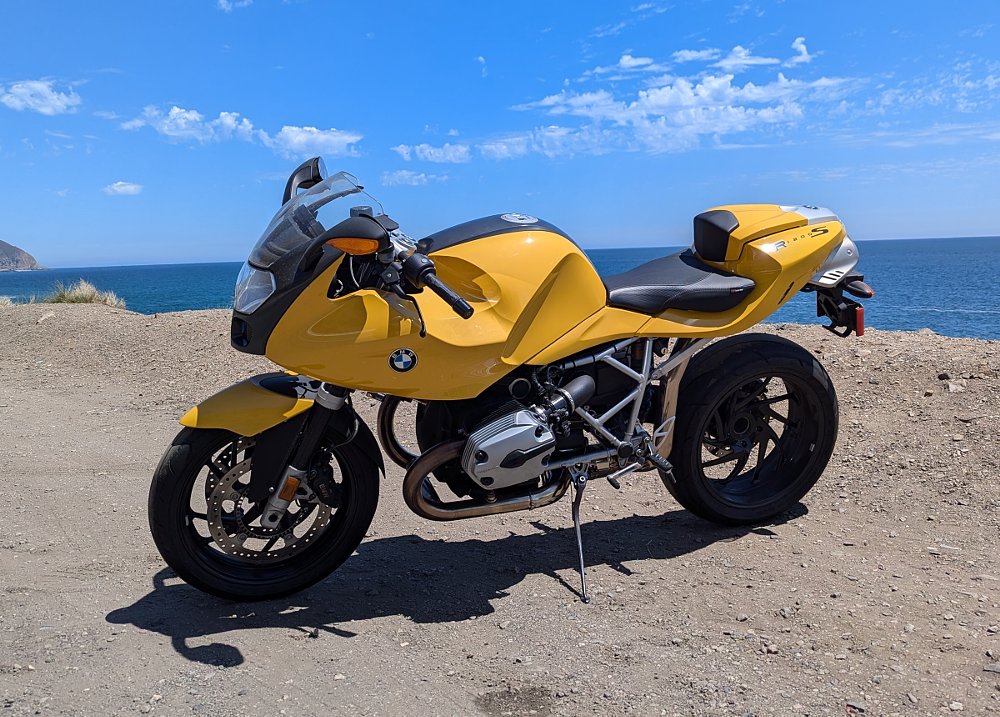 Yellow BMW R 1200 S parked at the beach