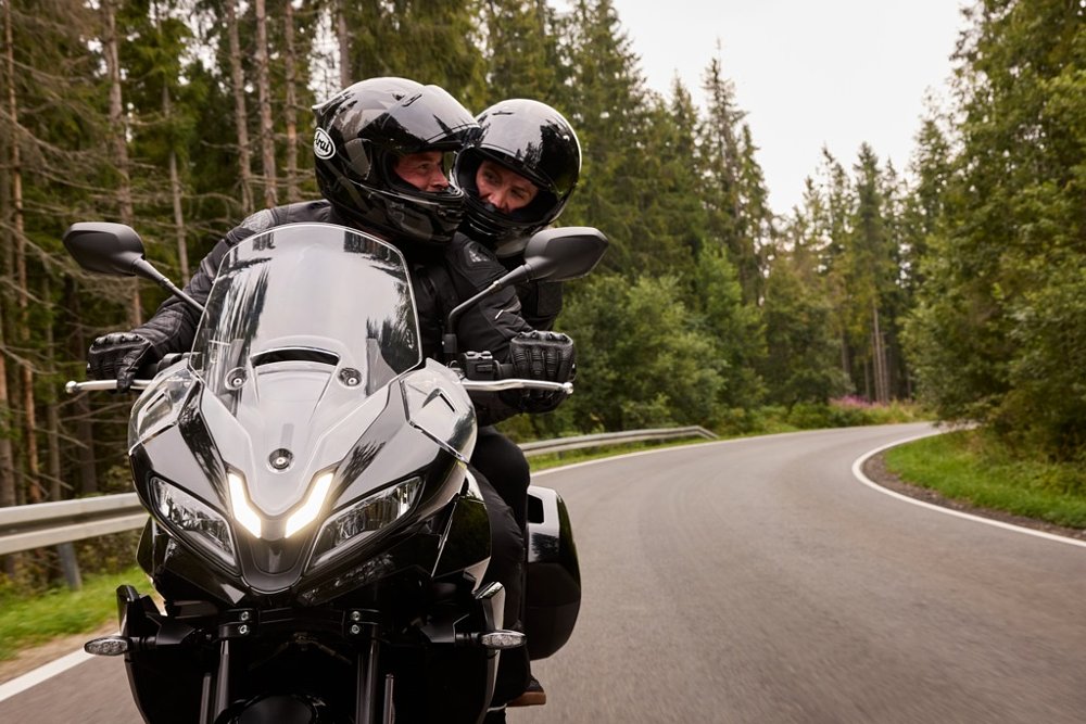 couple talking to each other while riding the Tiger Sport 800