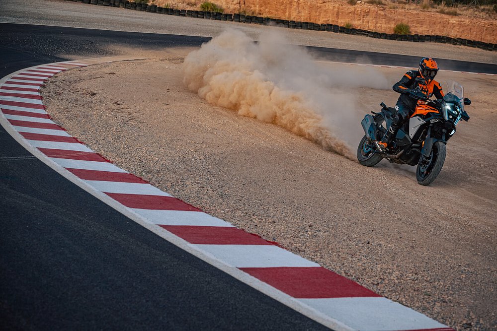 rider on the Super Adventure S Evo cutting through a gravel track on a race track