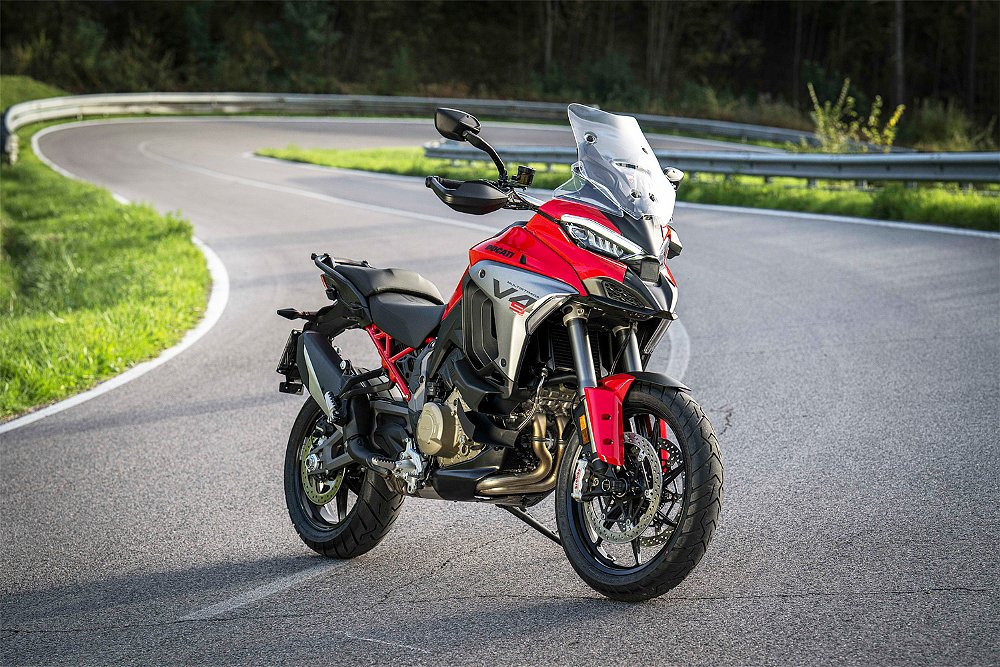 Resplendent in red, the Multistrada V4 S is parked along a curvy road.