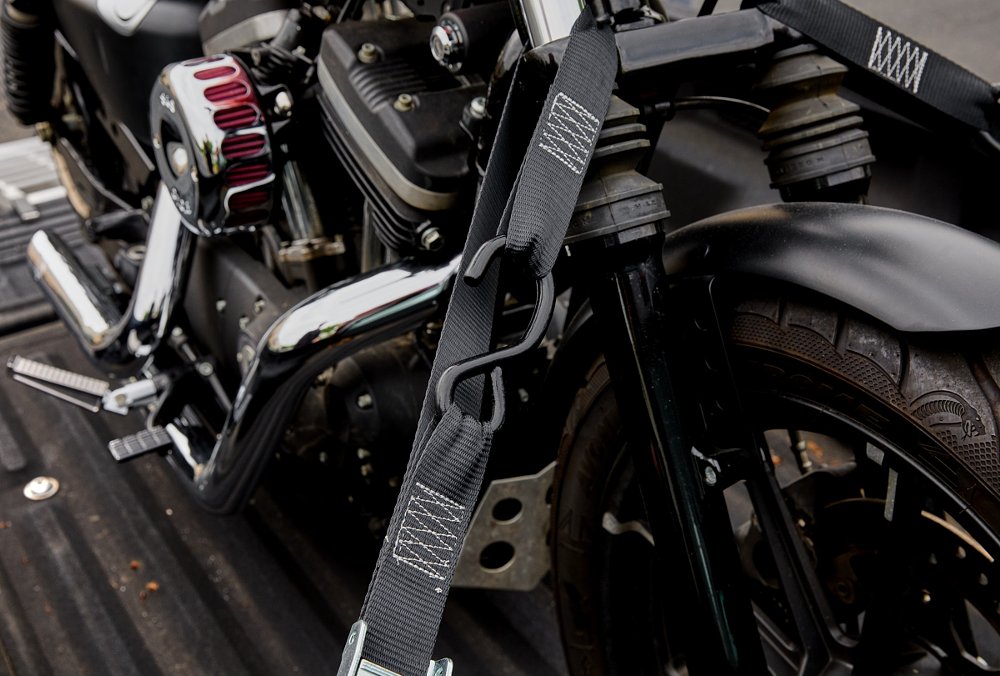 black Stockton straps holding a motorcycle on a lift