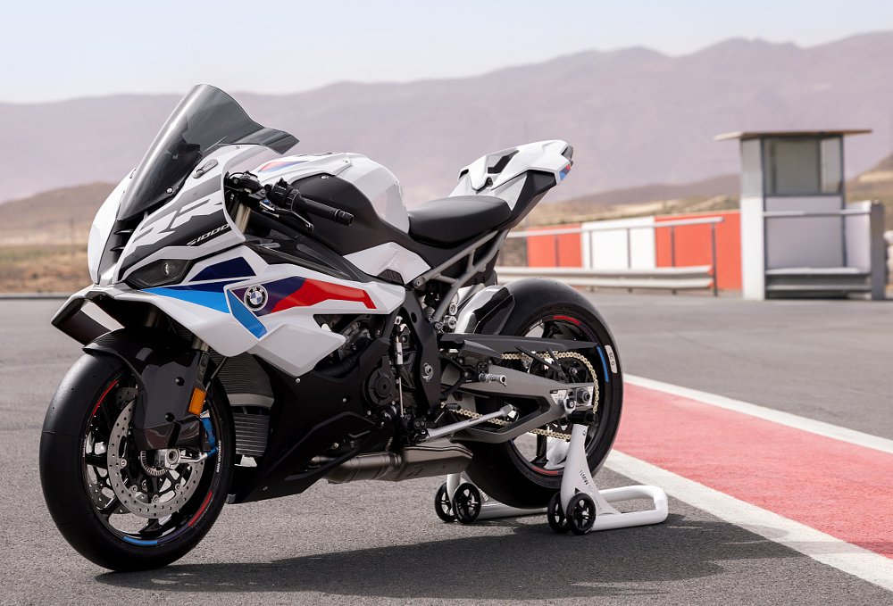 white S 1000 RR with red and blue accents on a paddock stand