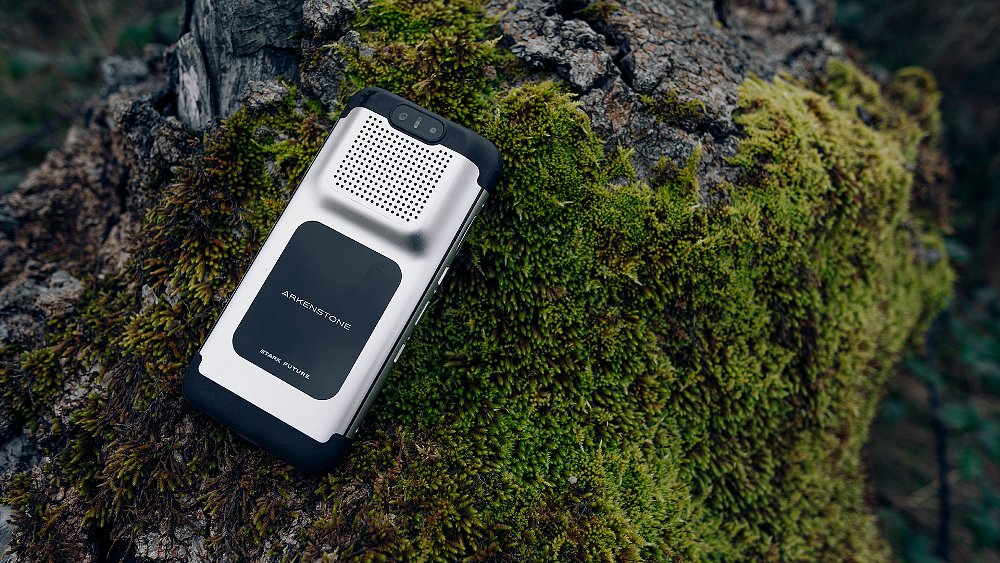 The VARG EX's Stark Arkenstone detachable mobile device rests on a moss-covered rock.