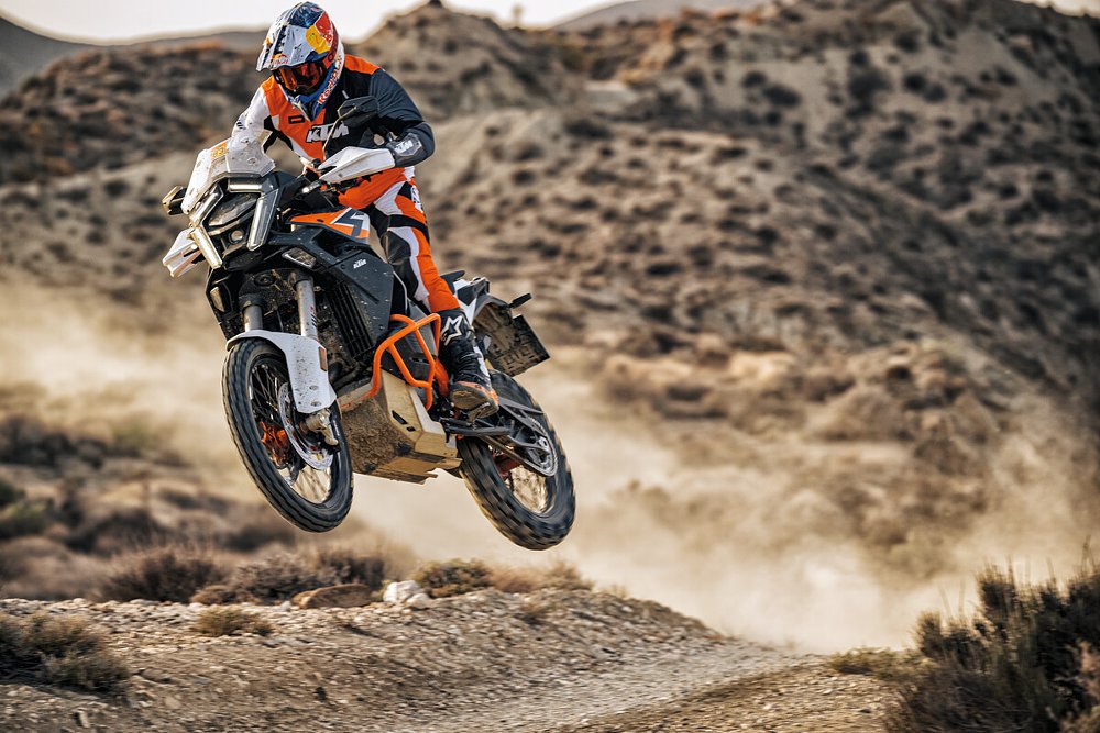 An ADV rider jumps the 509-pound (without fuel) 1390 Super Adventure R over a hill.