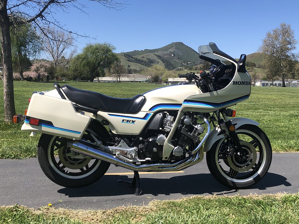 side view of a white Honda CBX with fairing and panniers