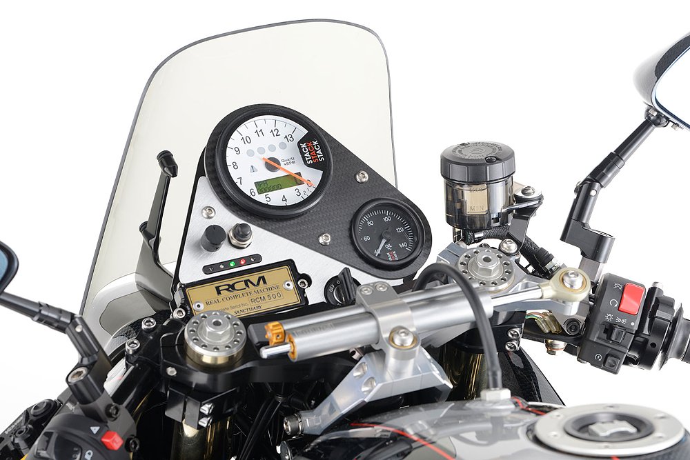 cockpit view showing gauges on the Katana and a gold RCM plaque on the top triple clamp