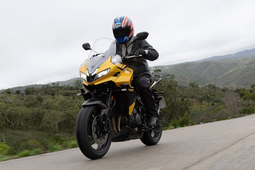 Dustin blasting down a backroad on the Tiger Sport 800. 