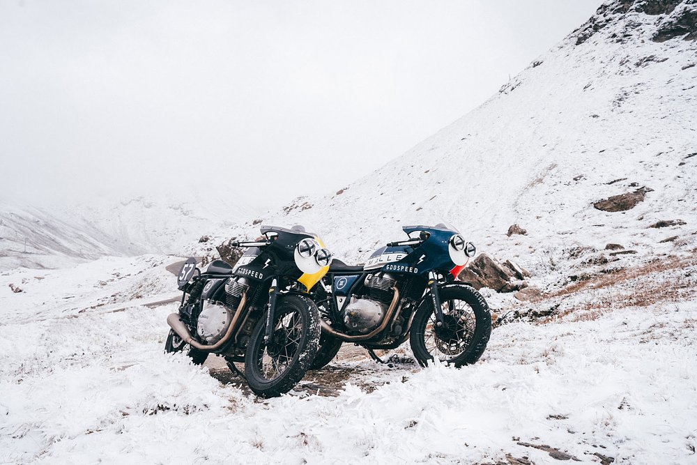 the two custom-painted Continental GT650s parked on a snowy mountain overlook