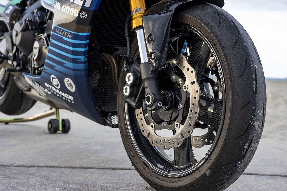 close view of the front wheel and Ohlins gold suspension parts