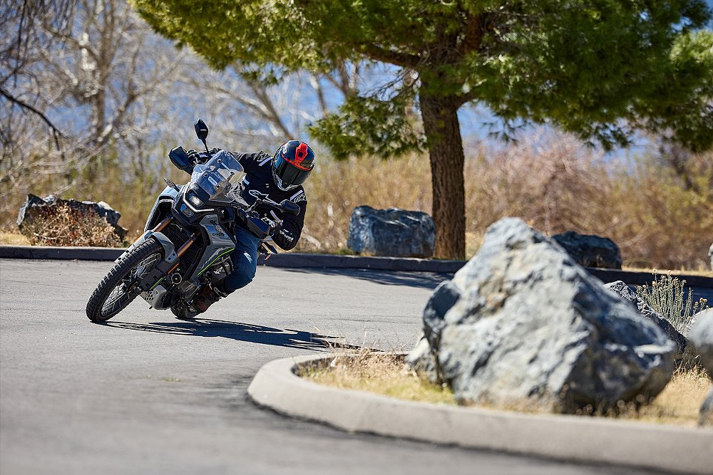 Dustin bends the CFMOTO Ibex 450 around a corner on the street.
