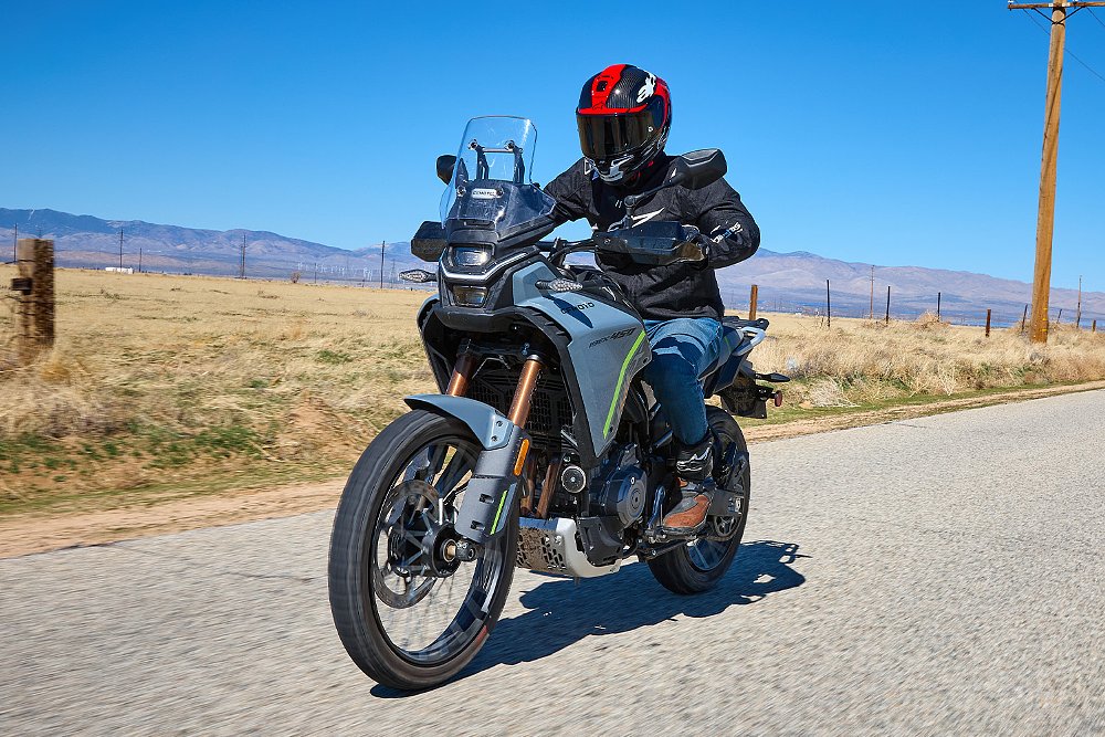 Clad in Alpinestars gear, Dustin rides the CFMOTO Ibex 450 down a country road.