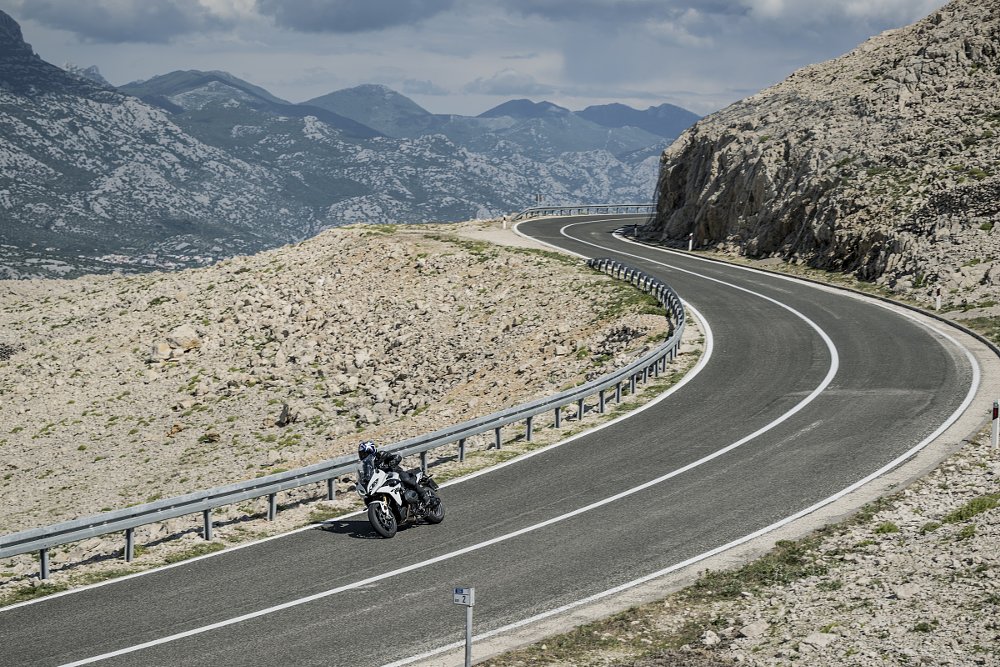 distant view of riding the BMW R 1300 RS on a mountain road