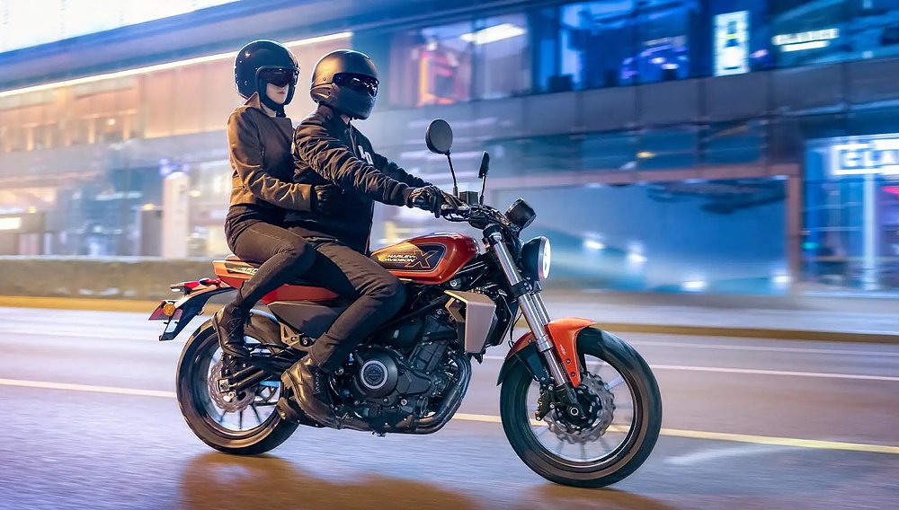 image of a couple riding a X 350 on a street in Asia