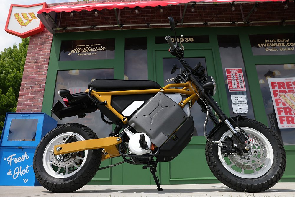 small electric LiveWire motorcycle on display in front of a whimsical storefront backdrop