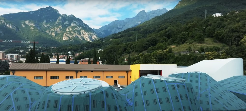 A shot of Moto Guzzi's newly renovated museum, with the nearby mountains providing a backdrop.