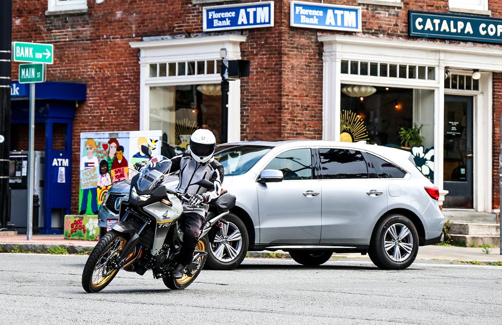 Transalp riding through an urban intersection