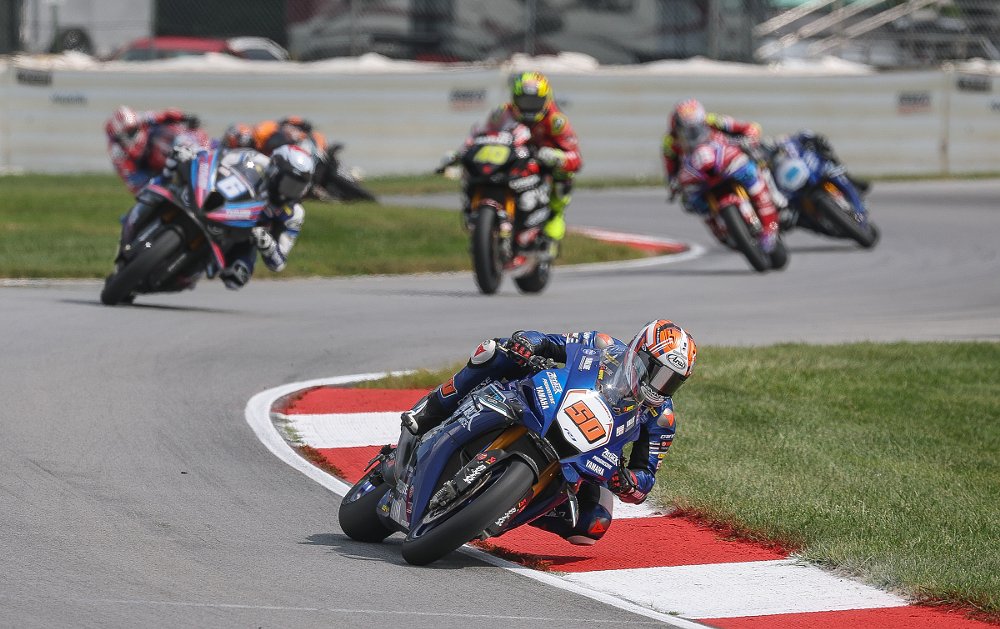 Fong leads the Superbike field through some turns during a race on his blue Yamaha YZF-R1