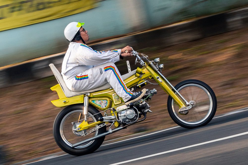 rider all dressed in white on the yellow Choppy Cub custom