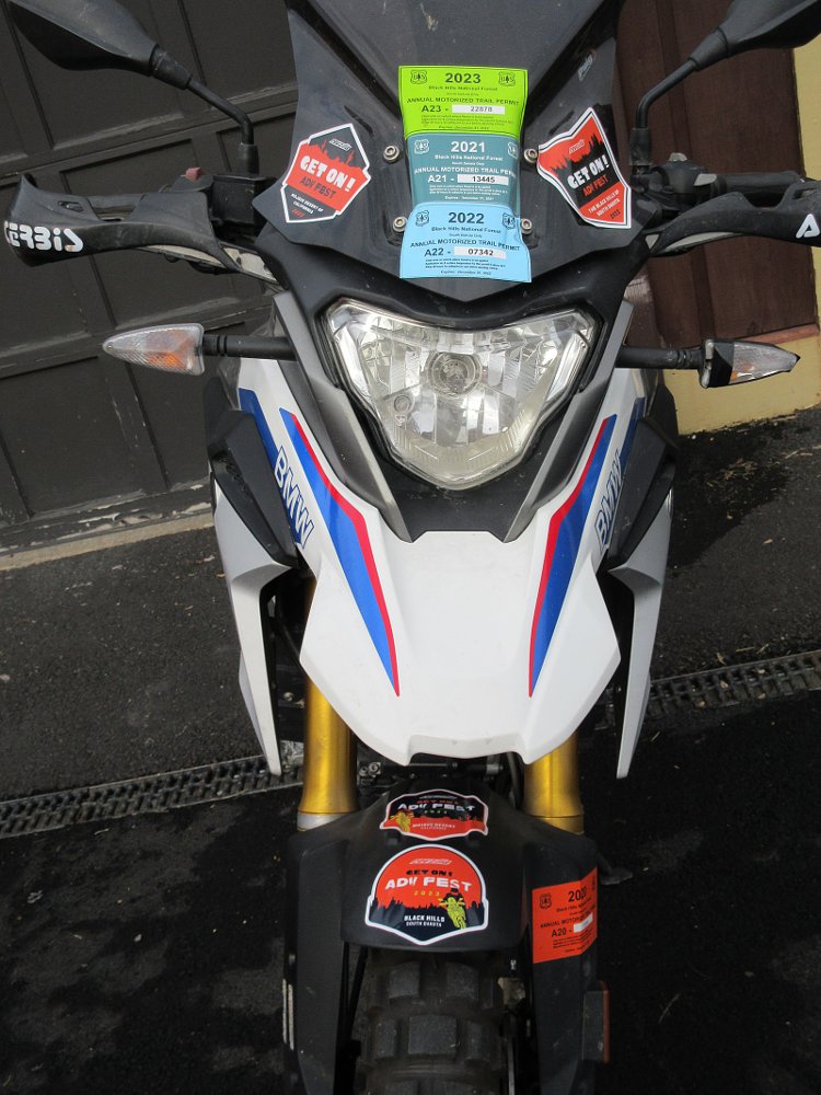 front view of the G 310 GS with multiple trail permit stickers and other stickers on the bodywork