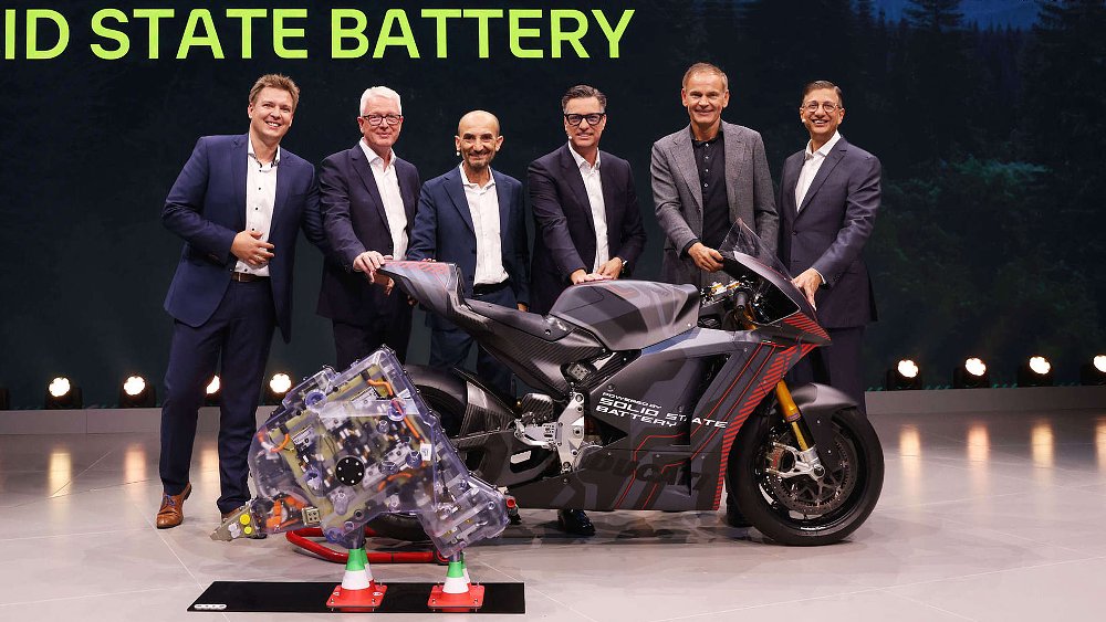 Volkswagen executives gather around the solid-state battery-powered Ducati V21L.
