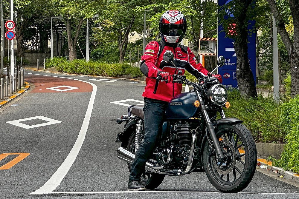 Mounted on the Honda GB350, Dustin stops at an intersection in Tokyo.